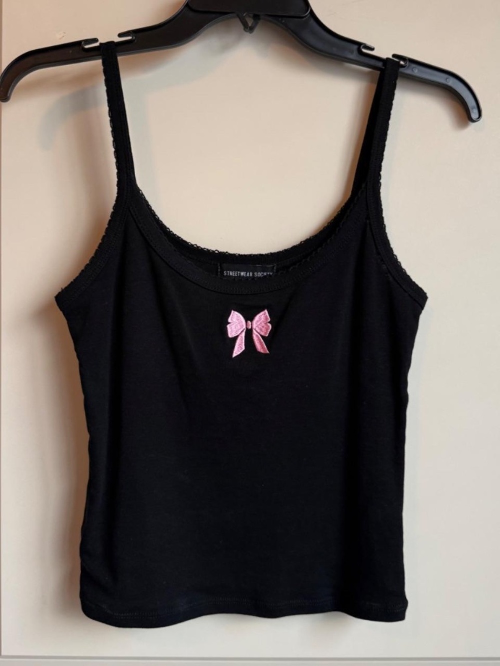 Small black tank top with pink bow and lace outlining from Charlotte Russe